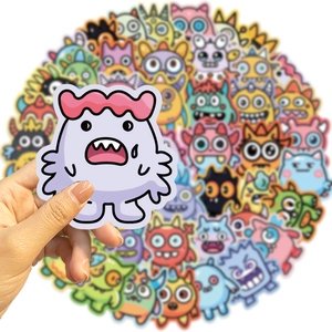 Close-up of a hand holding a cute purple monster sticker from a colorful waterproof set