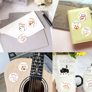 Roll of 500 thank you stickers with cute cat paw prints for envelope sealing and decor