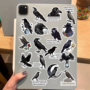 Artistic black raven stickers with vintage motifs on a tablet back lifestyle detail