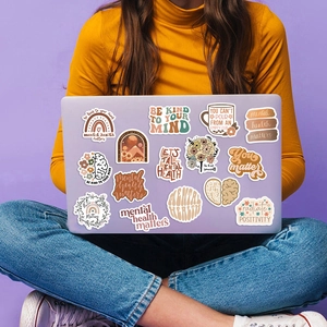 Detail of boho mental health stickers applied on a laptop for DIY decoration