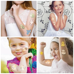 Close-up of cute cartoon animal temporary tattoos applied on children cheeks and arms