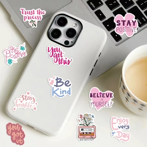Pink inspirational stickers shown on a white phone case and laptop with floral art