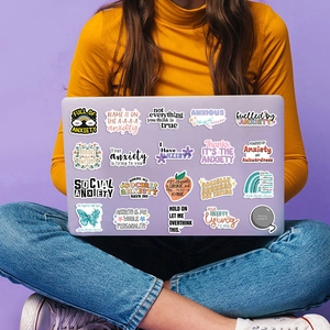Detail of anxiety sensory stickers on a laptop with floral and butterfly illustrations