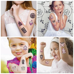 Close-up of colorful Halloween temporary tattoos on children's arms with magical patterns