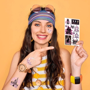 Close-up of Gothic Halloween temporary tattoos with castle and black cat motifs