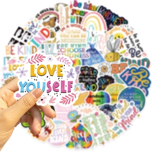 Close-up of waterproof Be Kind stickers with colorful inspirational quotes and floral icons
