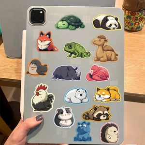 Close-up of waterproof cartoon animal stickers decorated on a tablet back with wood background