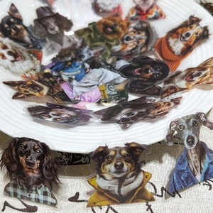 Close-up of waterproof dog stickers in a white ceramic dish for journal decoration