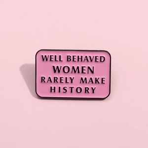Pink feminist enamel pin with 'Well Behaved Women Rarely Make History' quote