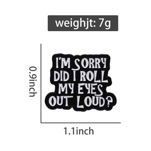 Detail view of the black I'M SORRY enamel pin showing size 1.1x0.9 inch and 7g weight