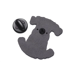 Detail of the back side of a dog-shaped metal brooch with a black rubber clutch pin