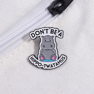 Funny grey hippo enamel pin with humorous text on white canvas bag accessory