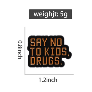 Detail view of Say No To Kids enamel lapel pin with orange text on black metal