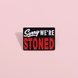 Rectangular enamel pin with Sorry We're Stoned funny text in black and red metal finish