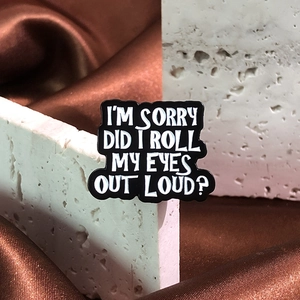 Funny enamel pin with I'm Sorry Did I Roll My Eyes Out Loud text on white stone surface