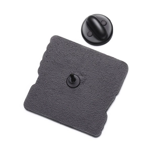 Macro view of square metal pin back with black sand texture and rubber butterfly clutch