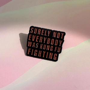 Black enamel badge with Kung Fu Fighting text on pink and green geometric background