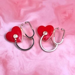 Detailed view of heart-shaped stethoscope enamel pins for doctors and nurses