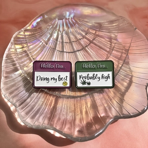 Colorful enamel pins set featuring Doing my best and Probably high quotes on shell tray