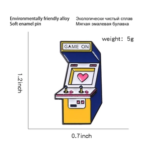 Retro game console enamel pin with heart and Game On text, showing 1.2 x 0.7 inch size
