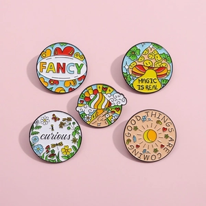 Detailed close-up of 5-piece pink pop art enamel pins with floral and magic motifs
