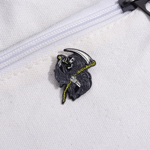 Retro Halloween grim reaper skull enamel pin with scythe on white canvas texture