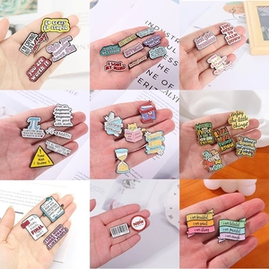 Set of colorful enamel pins with inspirational quotes and creative metal badges
