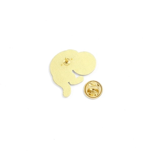 Close-up of golden enamel pin back showing metal butterfly clutch and sharp needle pin