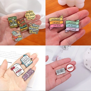 Macro shot of colorful enamel pins with motivational quotes and creative designs