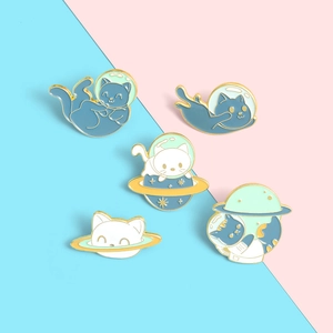 Set of five cute astronaut cat enamel pins with blue space theme and gold metal trim