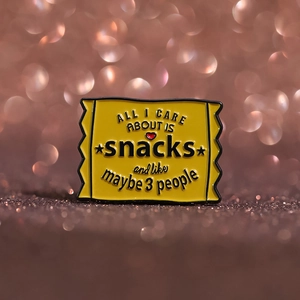 Cartoon snack bag enamel pin in yellow with humorous text and glossy metallic finish