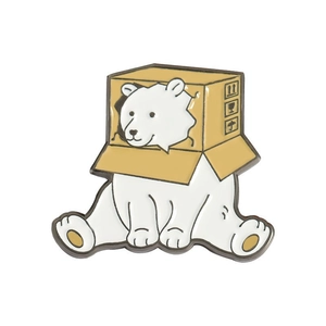 Cute polar bear enamel pin inside a cardboard box for jacket and bag accessories