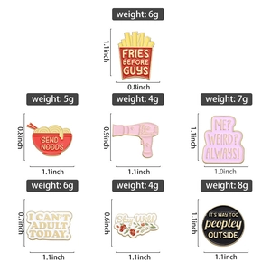 Detailed view of colorful enamel pins featuring fries, ramen, and hair dryer designs