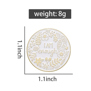 Detail view of 1.1-inch white enamel pin with I AM enough quote and floral pattern