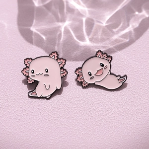Cute pink axolotl enamel pins in cartoon style on a dreamy soft water ripple background