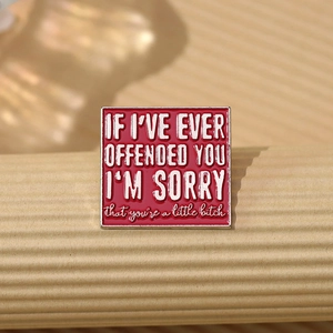 Square red enamel pin with silver lettering and humorous English apology quote