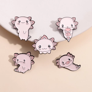 Detail of five pink cartoon axolotl enamel pins in various cute poses on a ceramic tray
