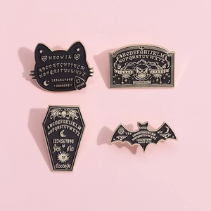 Set of four Halloween pins featuring black enamel cat, coffin, and bat with Ouija Board motifs