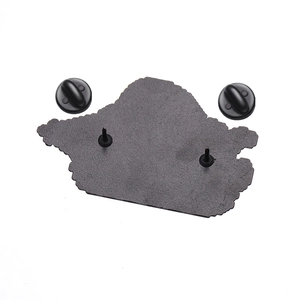 Detailed view of the metal enamel pin back with double pins and black rubber clutches