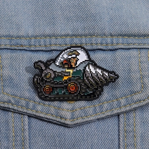 Pixel art enamel pin with tank design on denim jacket, 8-bit retro gaming accessory