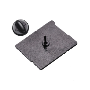 Detail of the matte black metal badge back with secure black rubber butterfly clutch pin