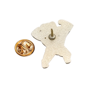Detail of the golden metal enamel pin back with a secure butterfly clutch fastener