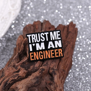 Trust Me I'm An Engineer enamel brooch pin on rustic wood background
