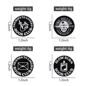 Detail of 1.2-inch black enamel pins featuring book club and horror movie themes