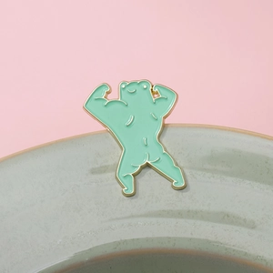Whimsical muscular frog enamel pin in light green finish with gold-toned metal outline