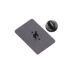 Detail of matte black metal brooch backing with needle pin and secure rubber clutch