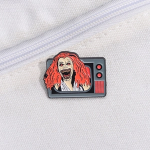 Retro TV enamel pin featuring a spooky red-haired character for Halloween accessory