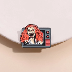 Spooky horror enamel pin featuring a red-haired zombie emerging from a retro TV set