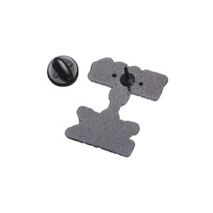 Detail view of the metal enamel pin back with a durable black rubber clutch fastener