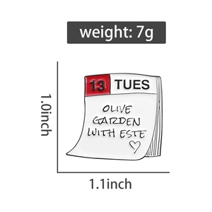 Detail of calendar enamel pin showing dimensions 1.0x1.1 inches and 7g weight